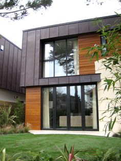 a modern house with wood siding and glass doors