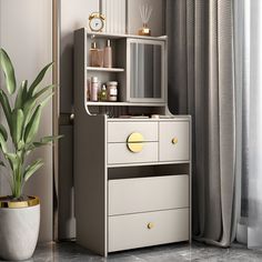 a white dresser sitting next to a potted plant