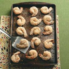 a pan filled with fried shrimp on top of a table