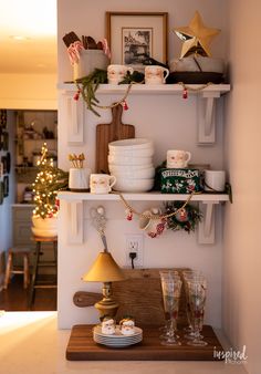 the shelves in this kitchen are decorated for christmas