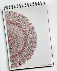 a spiral notebook with an intricate design on it