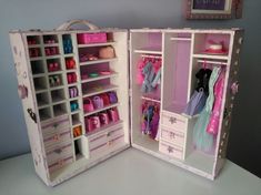 an open dollhouse closet with clothes and shoes on the shelves in front of it