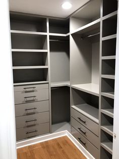 an empty walk in closet with shelves and drawers