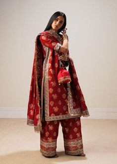 Traditional Look Red Embroidered Pakistani Wedding Dress Salwar Suit is block printed with delicate floral bunches all over . The sequined border addes splendid look to the whole outfit making it look extremely appealing. This outfit is perfect for festive and wedding season. Embroidered Kameez: The kameez has a Premium fabric and is emblazoned with lavish designs and embroidery. Beaming sequins and floral details make this beautiful chiffon kameez in an alluring black color a perfect choice to