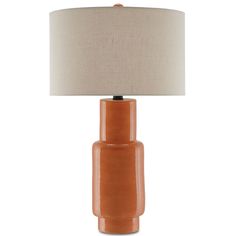 an orange table lamp with a beige shade