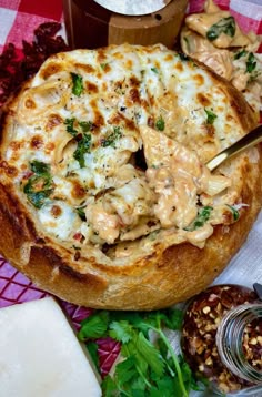 a pizza sitting on top of a table covered in cheese and sauce next to other food