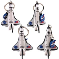 four space shuttle key chains are shown