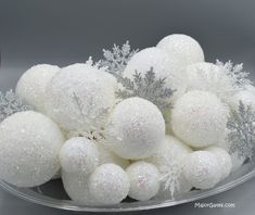 a bowl filled with white and silver ornaments