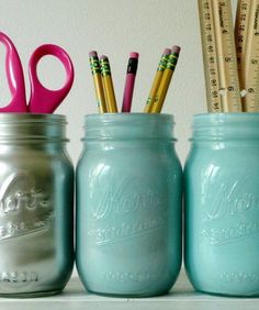 three mason jars with pencils, rulers and scissors