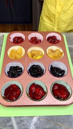 a muffin tin filled with cupcakes covered in jelly