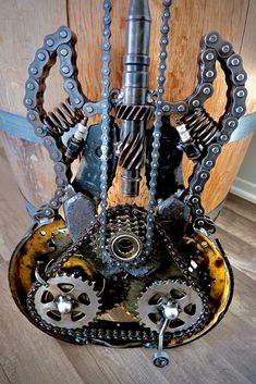 a clock made out of metal gears and chains