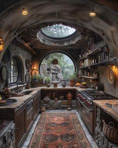 a kitchen with lots of counter space and an arched doorway leading to the outside area