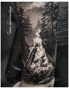 a man's arm with a black and white tattoo on it, depicting a mountain scene