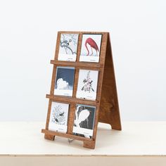 a wooden stand with four pictures on it