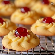 small pastries with cherry toppings on cooling rack