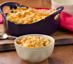 a casserole dish with macaroni and cheese in it on a cutting board