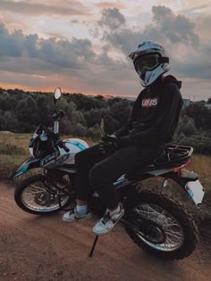 a man sitting on top of a dirt bike