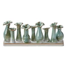 a group of vases sitting on top of a wooden stand