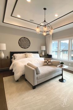 a bedroom with a large bed and white furniture