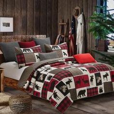 a bed room with a neatly made bed covered in plaid comforter and red pillows