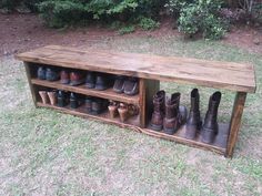 a wooden bench with many pairs of shoes sitting on it's sides in the grass