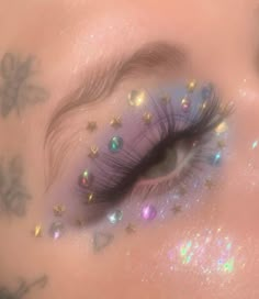 a close up of a person's eye with glitter on it