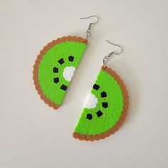 a pair of earrings made to look like a slice of pizza