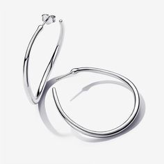 Play with linear curves when you wear the Organically Shaped 42 mm Open Hoop Earrings. This sterling silver set features slightly wavy open hoops with a rounded profile and varying thickness. The result is a delicate, fluid and organic look, evoking the ebbs and flows that can be found in nature. This earring set is a must-have addition to any hoop lover's collection, whether that's you or a stylish loved one. - Pandora Organically Shaped 42 mm Open Hoop Earrings - Sterling silver Hooped Earrings Pandora, Pandora Heart Earrings Silver, Pandora Heart Earrings, Silver Spiral Hoop Earrings Nickel-free, Spiral Nickel-free Metal Hoop Earrings, Pandora Essence, Custom Charm Bracelet, Pearl Charm Necklace, Open Hoop Earrings