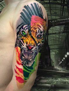 a man with a colorful tiger tattoo on his arm