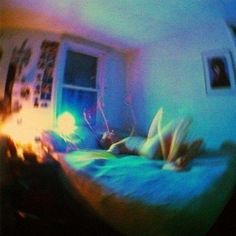 blurry image of a person laying on a bed in a room with a window