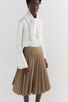 Our Khaki contrast pleated skirt is made of 100% wool, woven in Yorkshire at the mill Alfred Brown. The skirt is hand pleated in London. The skirt features two contrast pleats and a side entry invisible zip. Plated Skirt, Pleats Skirt, Tailored Coat, The Mill, Ivory Silk, Khaki Dress, Invisible Zip, Navy Women, Yorkshire