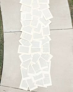 a pile of books sitting on top of a sidewalk