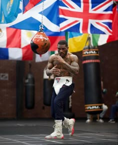 a man holding a basketball in front of flags