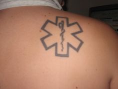 a person with a tattoo on their back has a star of life in the middle