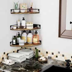 a bathroom sink with three shelves holding soaps and lotions on top of it