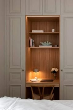 an open bookcase in the corner of a bedroom