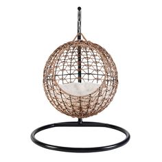 the hanging egg chair is made out of wicker and has a white pillow inside