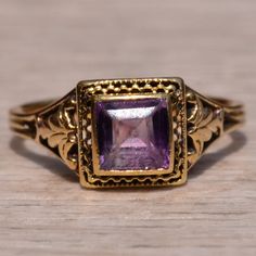 The Arnold Court: Antique Filigree Ring Set With Carre Cut Amethyst. The Ring Features A Square Carre Cut Natural Amethyst Center Bezel Set With A Halo Of Filigree. Filigree Continues Down The Shank And Throughout The Through-Finger View. The Ring Is Crafted In 14 Karat Yellow Gold And Is Currently A Finger Size 5 1/2 Yet Can Be Adjusted To Any Finger Size For An Additional Charge On Request. This Ring Remains One Of The Finest Examples Of Filigree We Have Owned. Antique Filigree, Amethyst Color, Filigree Ring, Bezel Setting, Womens Jewelry Rings, Ring Sets, Halo, Amethyst, Yellow Gold