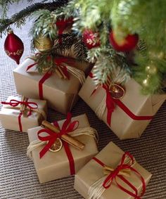 four wrapped presents under a christmas tree