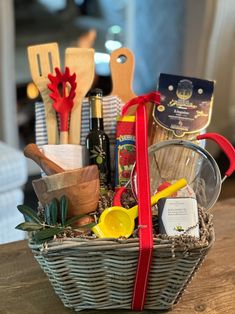 a basket filled with kitchen utensils on top of a wooden table