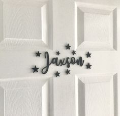 the name jalison written in metal stars on a white door with black lettering