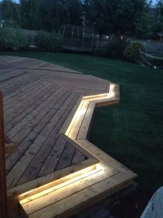 a wooden deck that has some lights on it