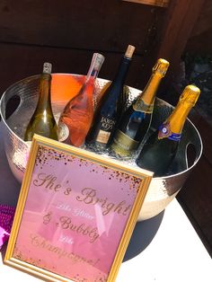 a metal bucket filled with bottles of wine and a sign that says me is bridal