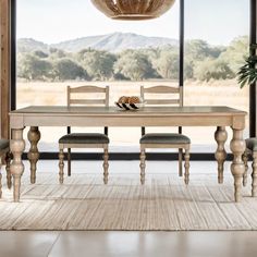 a dining room table and chairs in front of a large window with an outside view