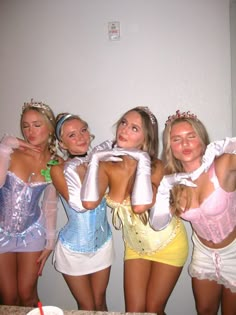 four women dressed in costumes posing for the camera