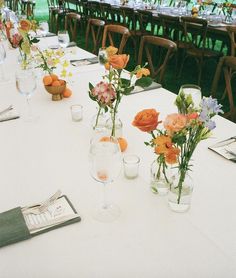 a long table with flowers and glasses on it