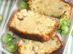 slices of bread on a plate with green grapes