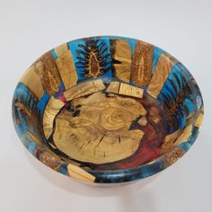 a wooden bowl with blue and yellow designs on it