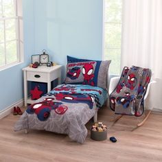 a child's bedroom with blue walls and spiderman bedding