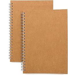 two brown spiral bound notebooks sitting next to each other